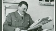 0Hitler-smiles-while-reading-newspaper-300x219