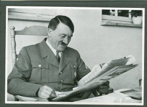 0Hitler-smiles-while-reading-newspaper-300x219