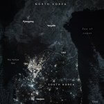 NASA nighttime image of the Korean Peninsula showing South Korea glowing with city lights while North Korea remains largely dark beyond the DMZ.