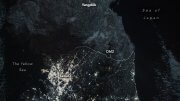 NASA nighttime image of the Korean Peninsula showing South Korea glowing with city lights while North Korea remains largely dark beyond the DMZ.